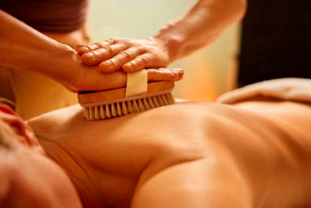 Warm dry-brush massage treatment at AURA Salon & Spa